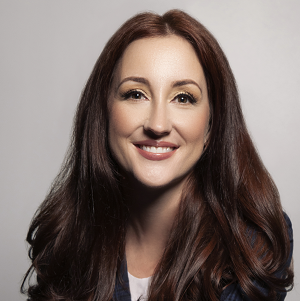 Portrait of a man with glasses wearing a gray shirt.